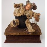 AN EARLY 20TH CENTURY AUTOMATON in the form of a baby doll in basket clothed in Victorian style lace