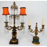 A BRONZE AND ORMOLU TABLE LIGHT of candelabra form with cut glass lustre drops, the body with