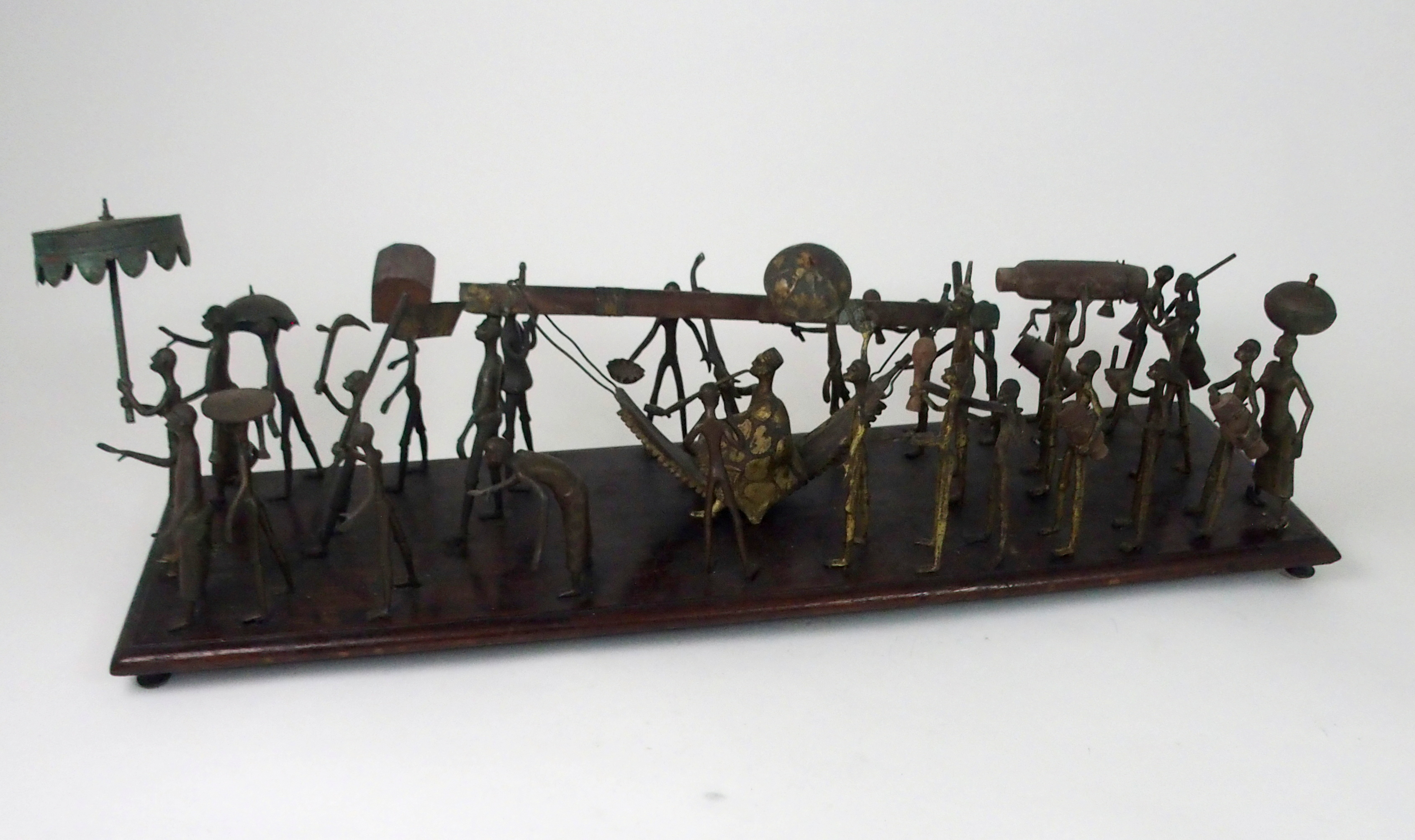 A DAHOMEY PROCESSIONAL GROUP, BENIN in brass and wood, with twenty nine figures, mounted on a