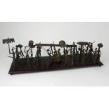 A DAHOMEY PROCESSIONAL GROUP, BENIN in brass and wood, with twenty nine figures, mounted on a