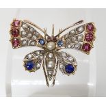 A VINTAGE GEM SET BUTTERFLY BROOCH embellished with rubies, sapphires, pearls and rose cut diamonds.