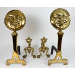 A PAIR OF POLISHED BRASS SMILING MOON FACE FIRE DOGS supported upon plain brass and iron stands,