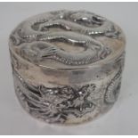 A CHINESE SILVER CIRCULAR BOX decorated with dragons,stamped WH, 9cm diameter, 186 grams