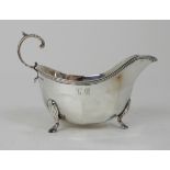 A SILVER SAUCEBOAT by Brook & Son, Sheffield 1911, of classical form with open scrolling handle on