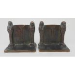 A PAIR OF GRIFFOUL EGYPTIAN STYLE BRONZE BOOKENDS each depicting two sarcophagus flanking a urn with