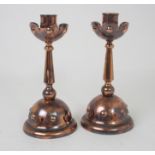 A PAIR OF W.A.S. BENSON STYLE COPPER CANDLESTICKS with rivet type decoration, 20cm high Condition