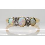 AN 18CT OPAL AND DIAMOND RING the gems are set into a millgrained tubed galleried mount, the central