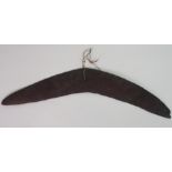 AN AUSTRALIAN BOOMERANG one side raised and the underside flattened, 19th century, 52cm long
