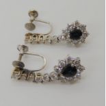 A PAIR OF SAPPHIRE AND DIAMOND DROP EARRINGS mounted in 10k white gold throughout, the pear shaped