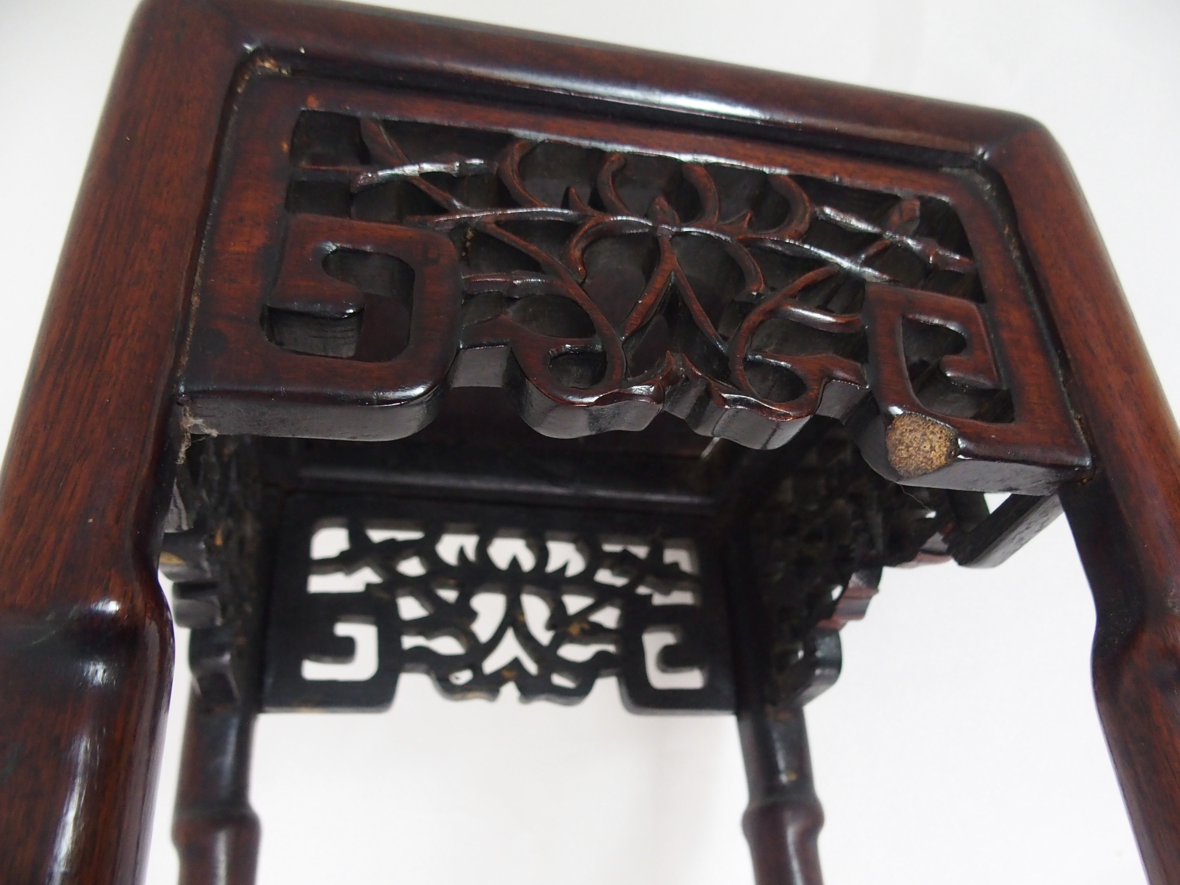 A CHINESE HARDWOOD VASE STAND the square top above foliate and key pattern frieze and on slender - Image 4 of 7