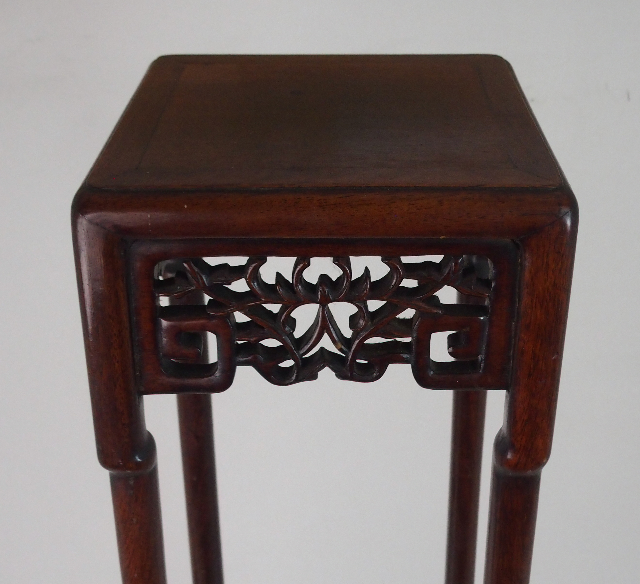 A CHINESE HARDWOOD VASE STAND the square top above foliate and key pattern frieze and on slender - Image 2 of 7