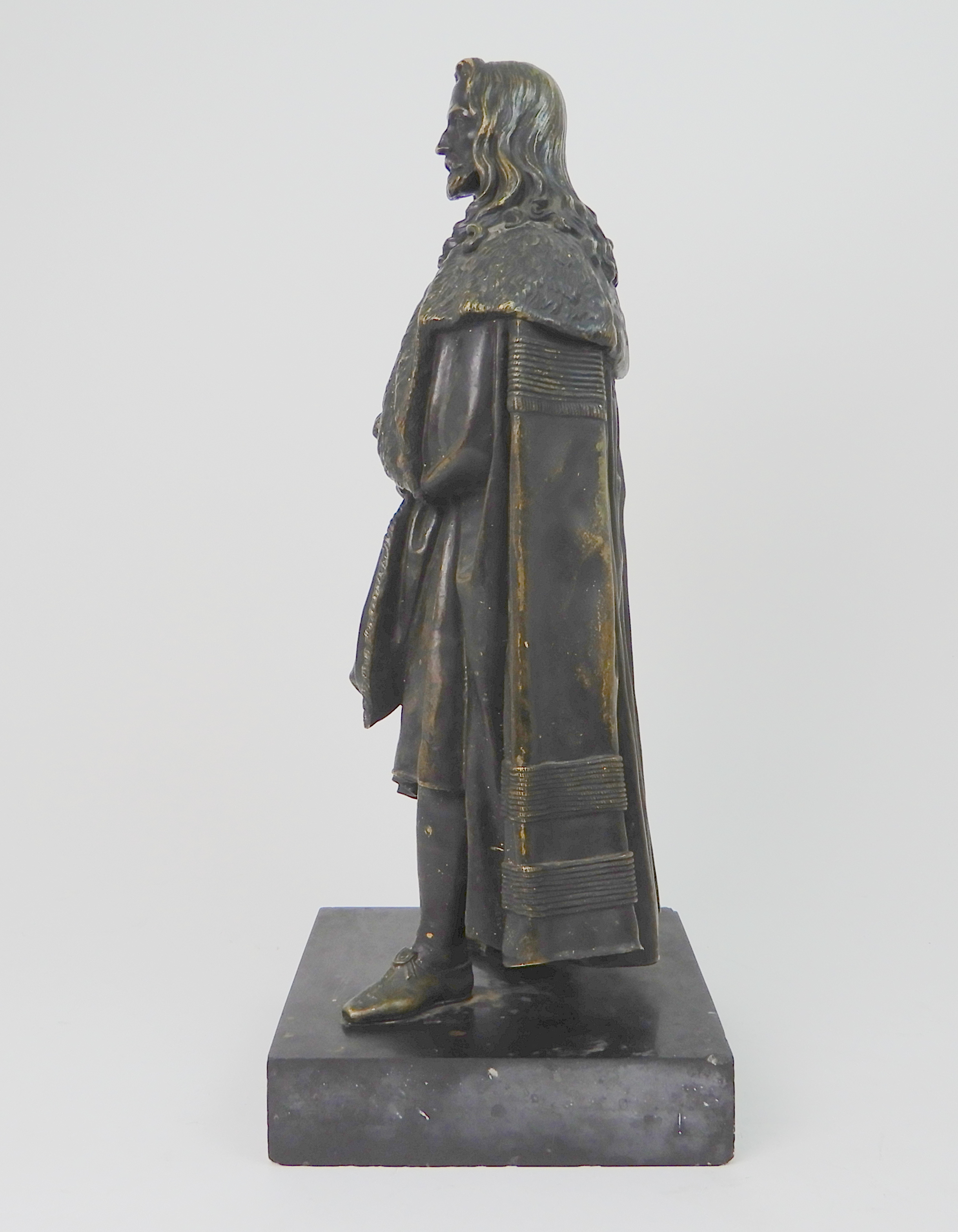 A BRONZED MODEL OF A MAN wearing fur trimmed robes, upon slate base, 46cm high Condition Report: - Image 6 of 7