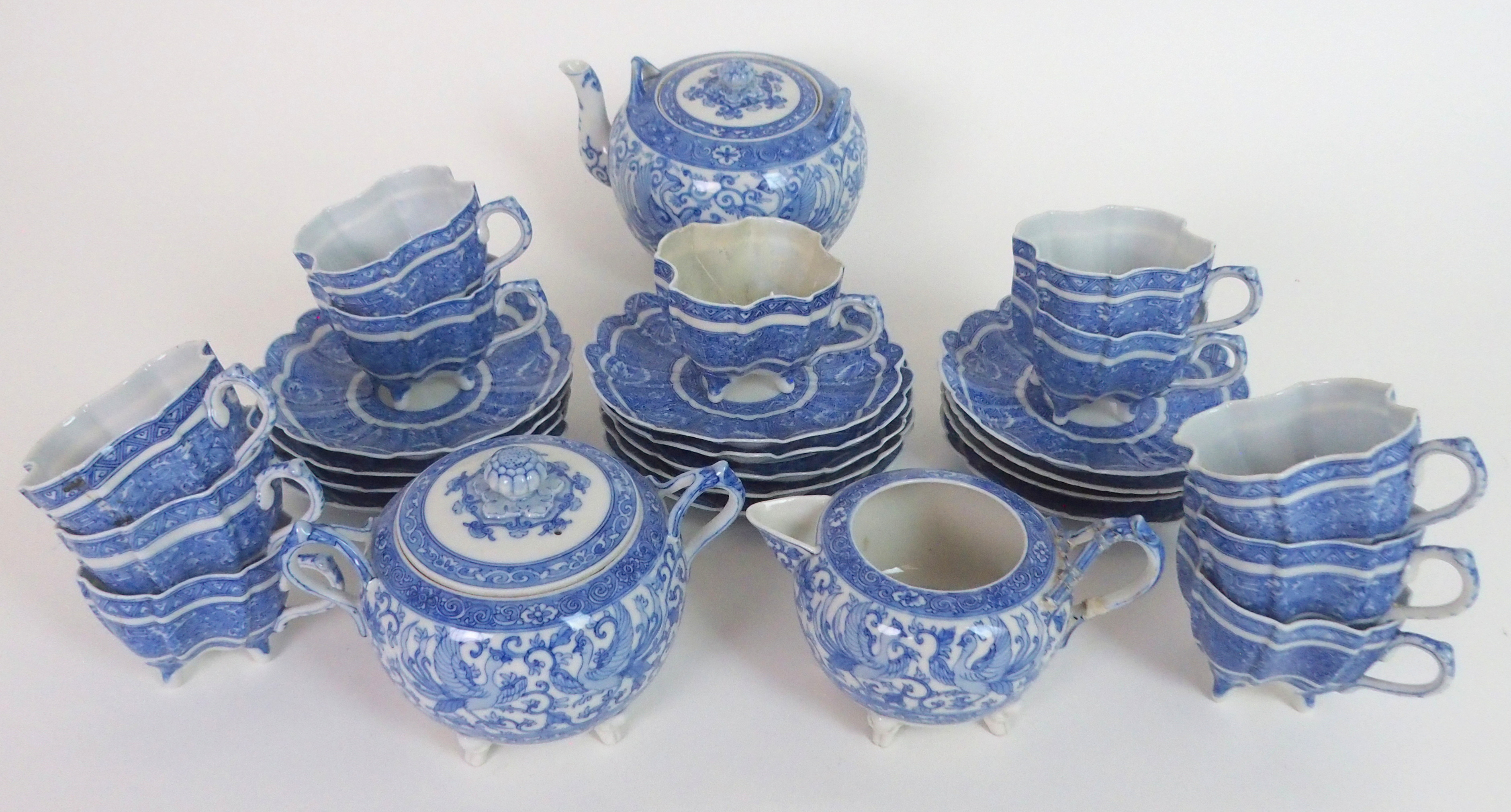 A JAPANESE BLUE AND WHITE TEA SERVICE finely painted all over with Ho-o birds and scrolling foliage,