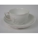 A MEISSEN WHITE GLAZED CUP AND SAUCER with applied prunus branch decoration, cup 4cm high