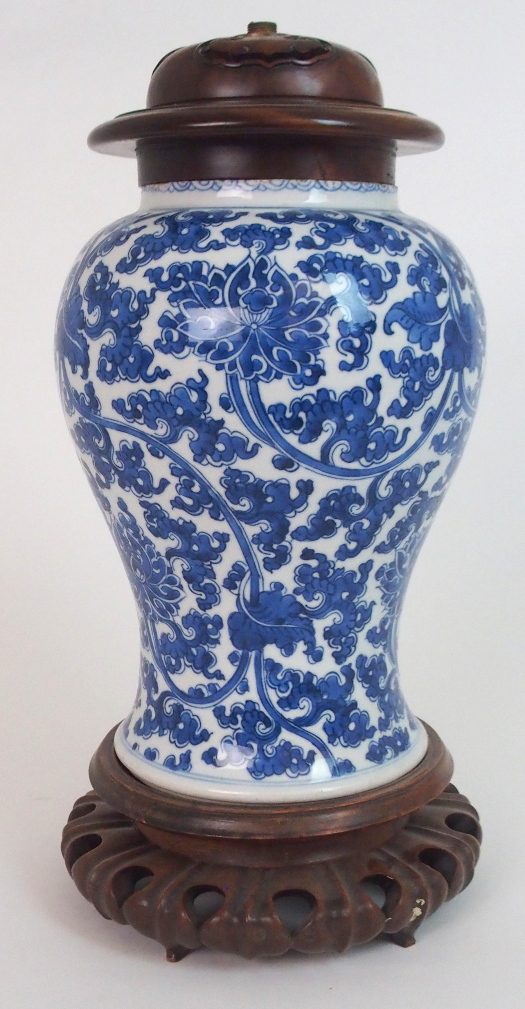 A CHINESE BLUE AND WHITE BALUSTER VASE painted with peonies and scrolling foliage, fitted with later