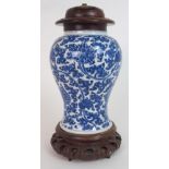 A CHINESE BLUE AND WHITE BALUSTER VASE painted with peonies and scrolling foliage, fitted with later