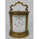 A 19TH CENTURY LARGE OVAL BRASS REPEATING CARRIAGE CLOCK the white dial with Roman Numerals and
