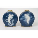 A PAIR OF MINTON PATE SUR PATE MOON FLASKS decorated by Marc Louis Solon, one with a girl cherub,