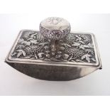 A CHINESE WHITE METAL INK BLOTTER the handle engraved with a monogram, above peonies and foliage,