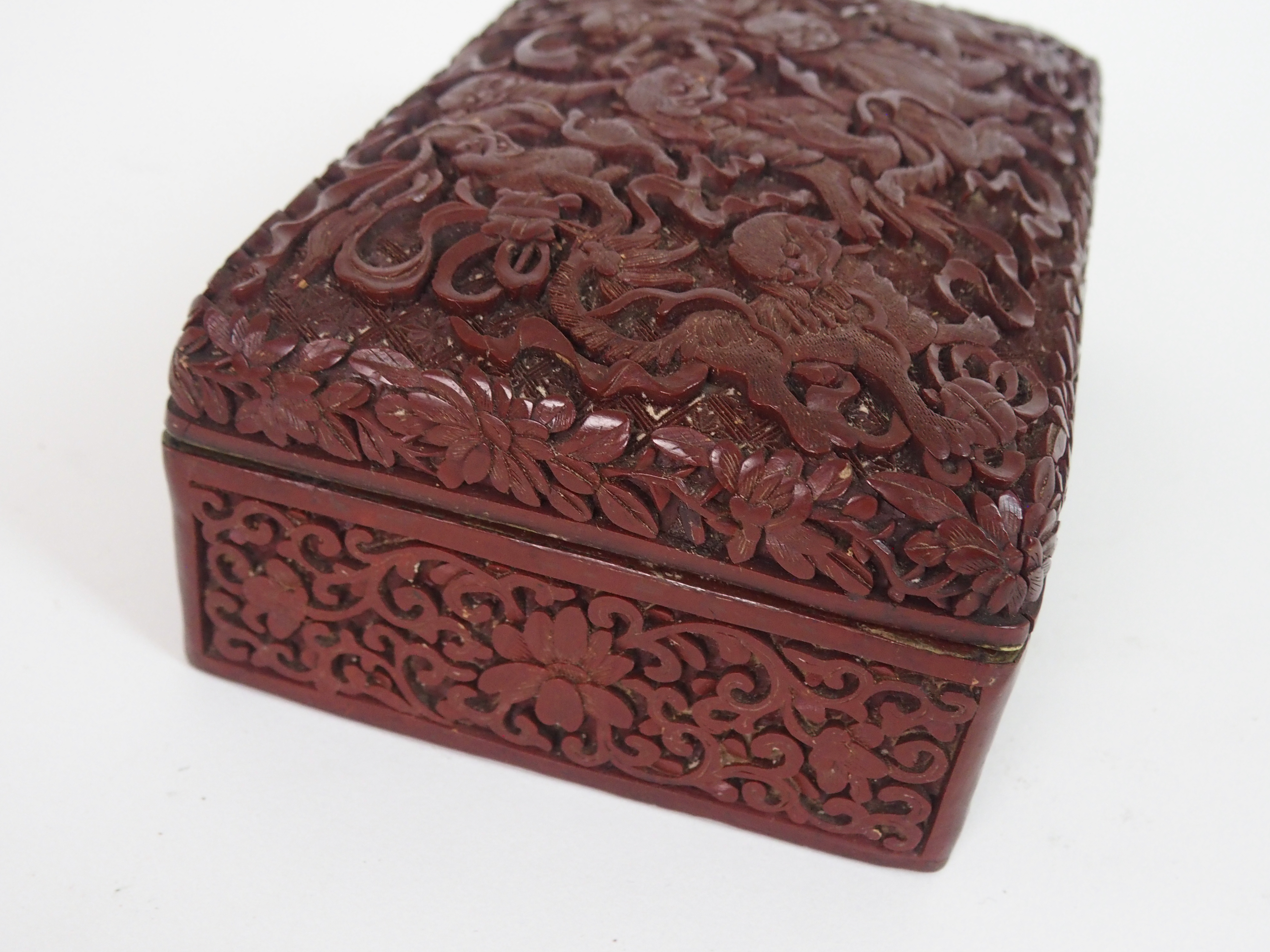 A CHINESE CINNABAR BOX AND COVER carved with kylin with precious objects and ribbons, above - Image 3 of 4