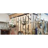 Two brass chandeliers, glass shades, a pair of brass wall lights and two floral metal chandeliers (