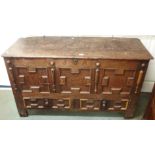 An oak coffer with panel front with two lower drawers and S A carved initials, 73cm high x 132cm