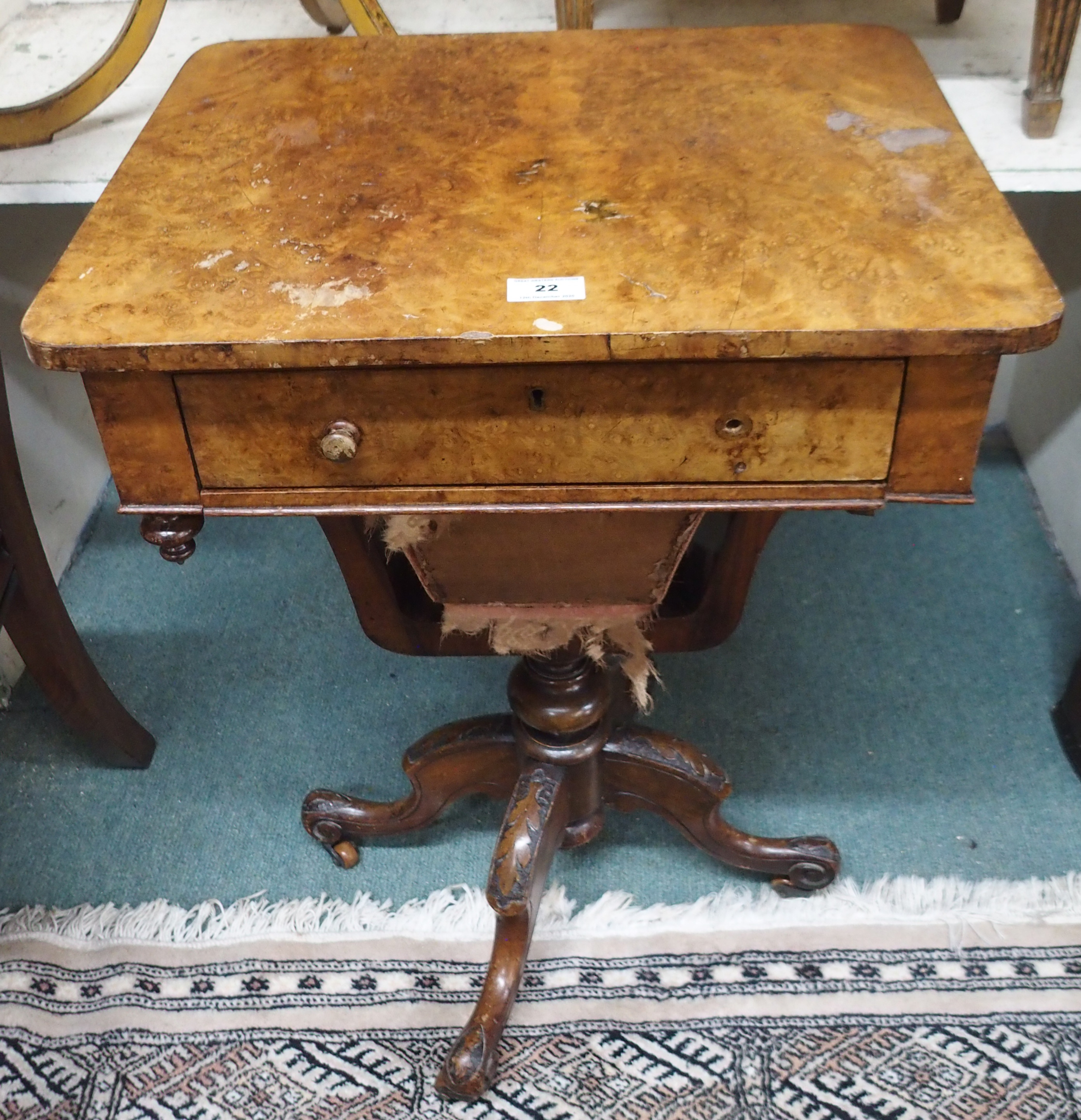 A Victorian walnut sewing table on carved base Condition Report: Available upon request