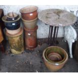 A garden table and assorted planters and chimney pots Condition Report: Available upon request