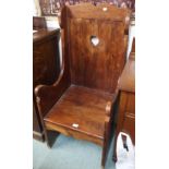 A hardwood monks chair with pierced back, 120cm high x 56cm wide Condition Report: Available upon