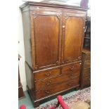 A mahogany linen press with two doors over two over three drawers on bracket feet, 202cm high x