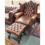 A tan leather Chesterfield wingback armchair and matching footstool (2) Condition Report: