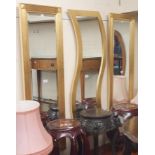 A pair of modern gilt wall mirrors, 128cm x 43cm with a wavy edge gilt mirror (3) Condition