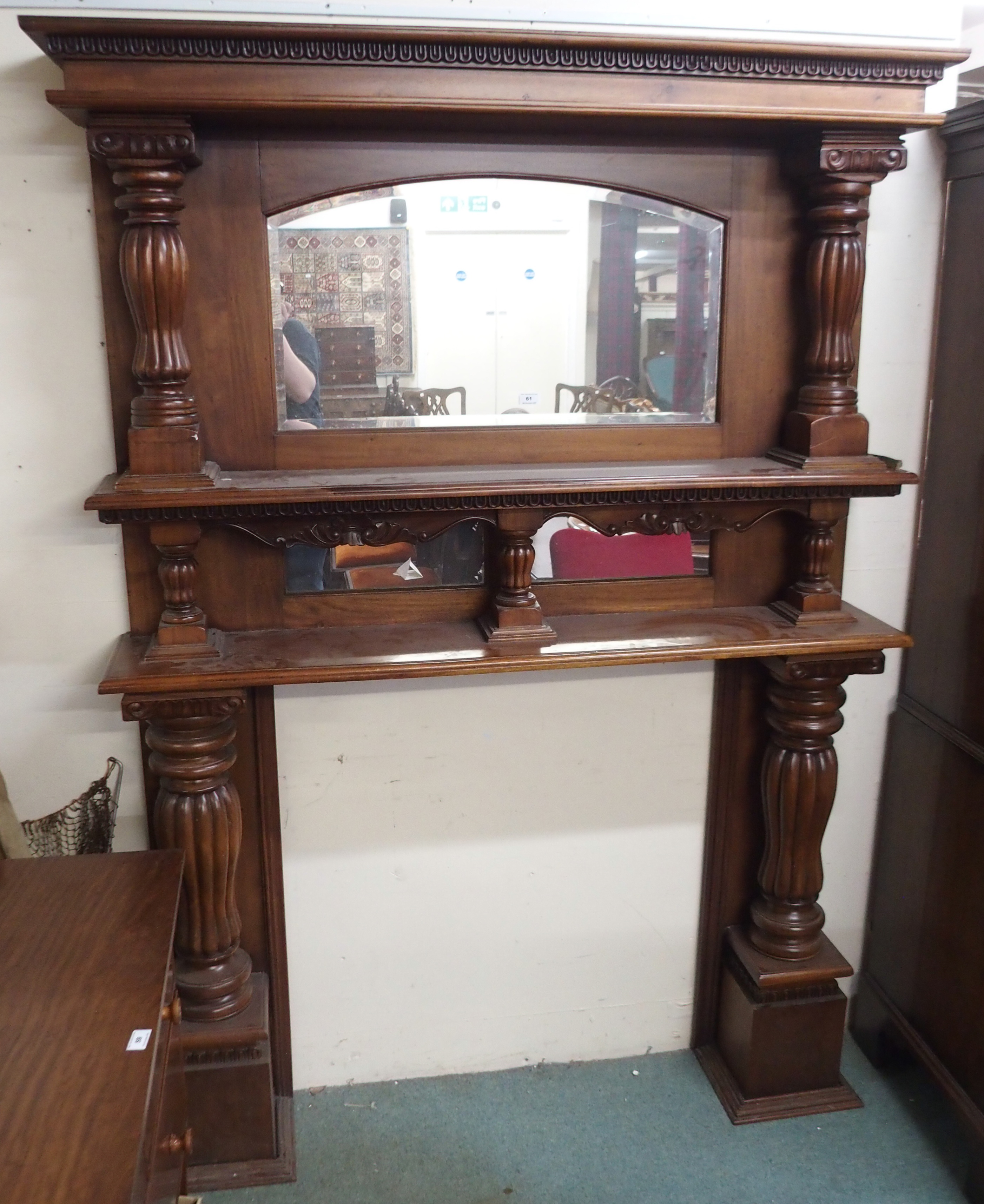 A large mahogany carved fire surround with mirror back and column supports, 209cm high x 148cm