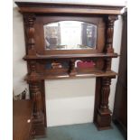 A large mahogany carved fire surround with mirror back and column supports, 209cm high x 148cm