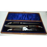 A cased three piece horn handled carving set Condition Report: Available upon request