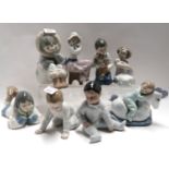 Six Nao figures including two Eskimo children, boy asleep on rocking horse, along with two Nadal