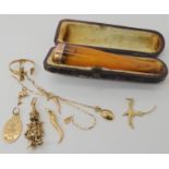 An 18ct gold horn of plenty pendant, weight 0.9gms, 14k gold bird pendant, weight 1.1gms, 9ct gold