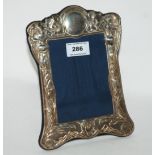 A silver mounted photo frame, Sheffield 1991, rectangular with flowerheads and leafy tendril