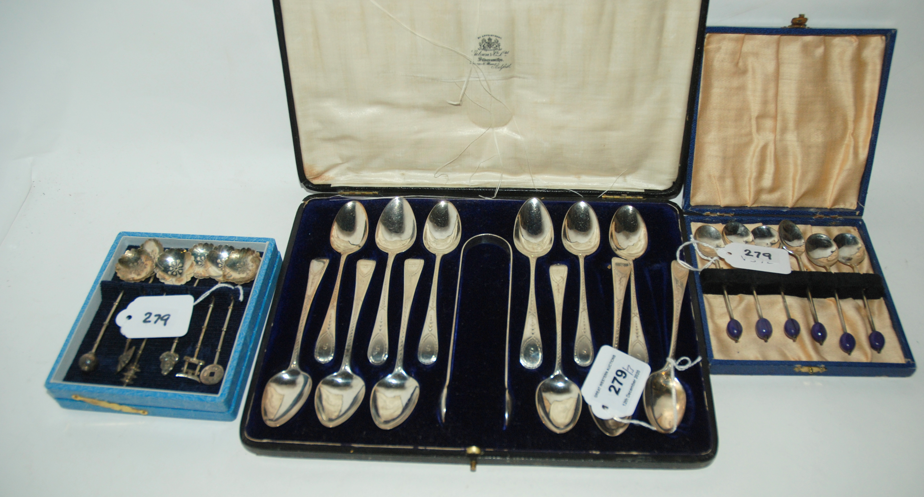 A lot comprising a cased set of twelve silver teaspoons with tongs, a cased set of EP coffee bean
