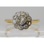 An 18ct diamond flower cluster ring set with estimated approx 0.47cts (as is one diamond missing)