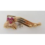 A 9ct gold and platinum diamond and ruby brooch, length 5.3cm, weight 8.9gms Condition Report: