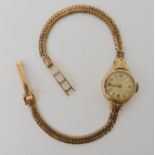 A 9ct gold ladies Rotary Maximus watch with integral herringbone pattern strap, length 17.5cm,