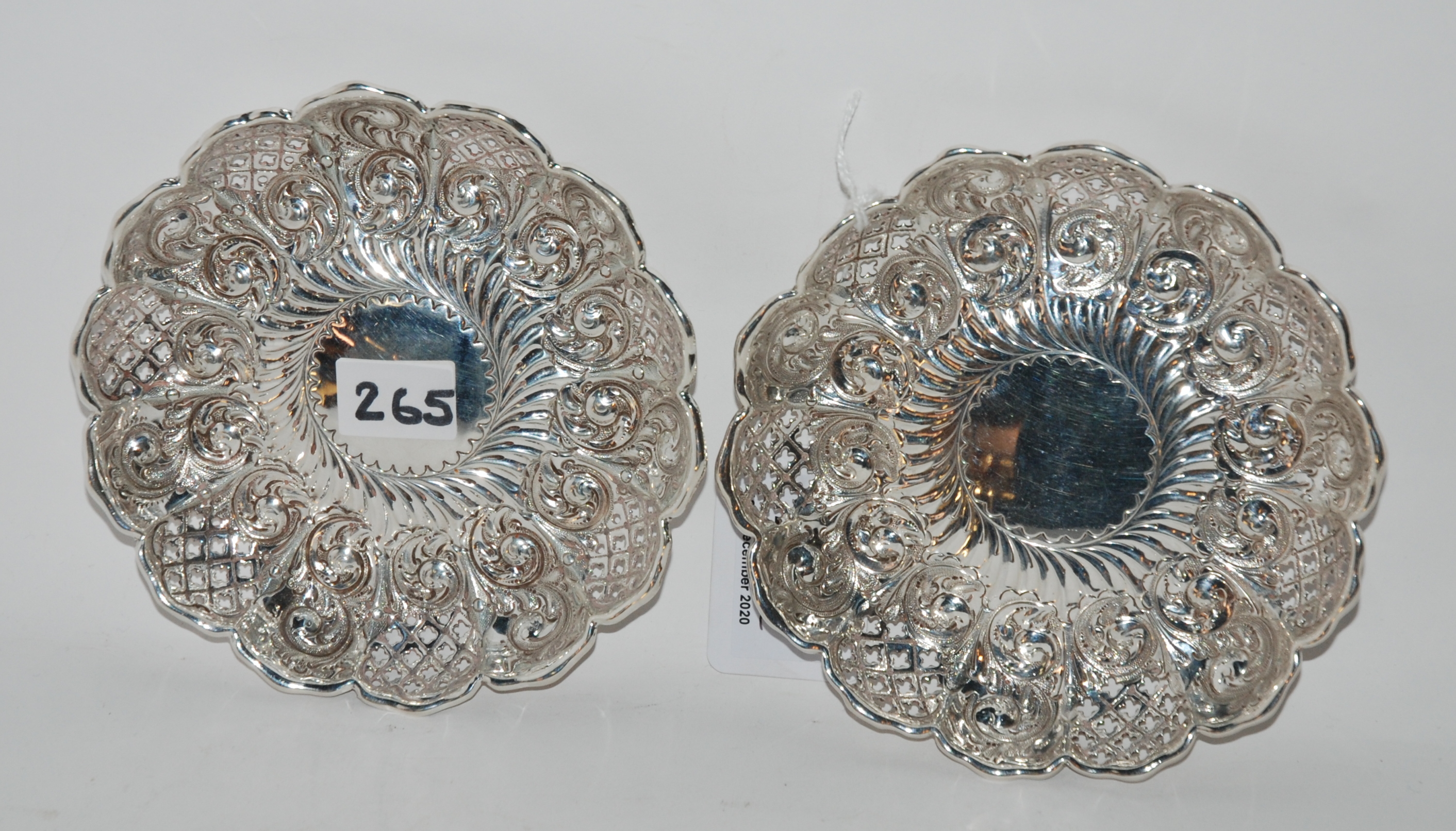 A pair of silver dishes, Sheffield 1895, of circular form with scalloped rim and pierced and foliate