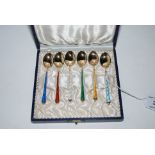A cased set of six sterling silver gilt and enamel coffee spoons Condition Report: No damage.
