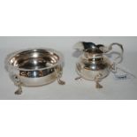 A white metal cream and sugar with engraved decoration (2) Condition Report: Available upon request