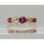 An 18ct gold ruby and diamond ring with scrolled setting, hallmarked London 1918, weight 2.4gms
