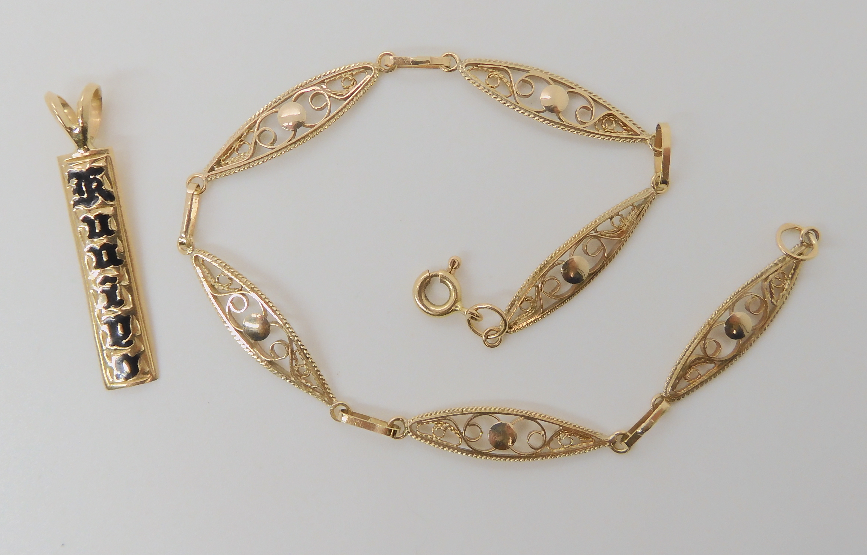 A 14k gold filigree bracelet, length 19cm and a 14k pendant, weight combined 4.6gms Condition