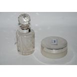 A lot comprising a silver topped talcum jar, London 1954 and a silver mounted dressing table jar,