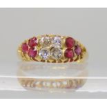 A bright yellow metal ruby and diamond ring, set with estimated approx 0.20cts of old cut