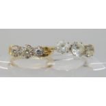 An 18ct gold three stone illusion set diamond ring with unusual shoulder design, set with